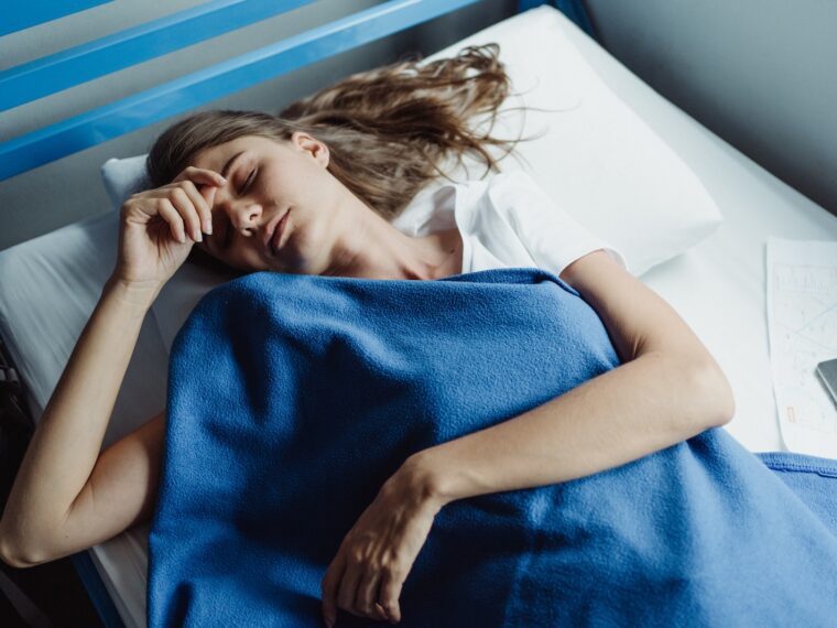 Woman Sleeping Under a Blue Blanket 