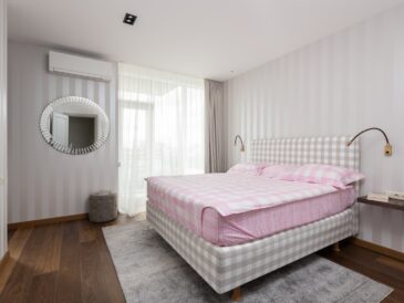 Interior of bedroom with comfortable bed and light walls