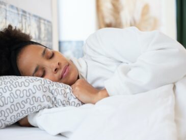 Woman Wearing White Long Sleeve Shirt Sleeping on Bed