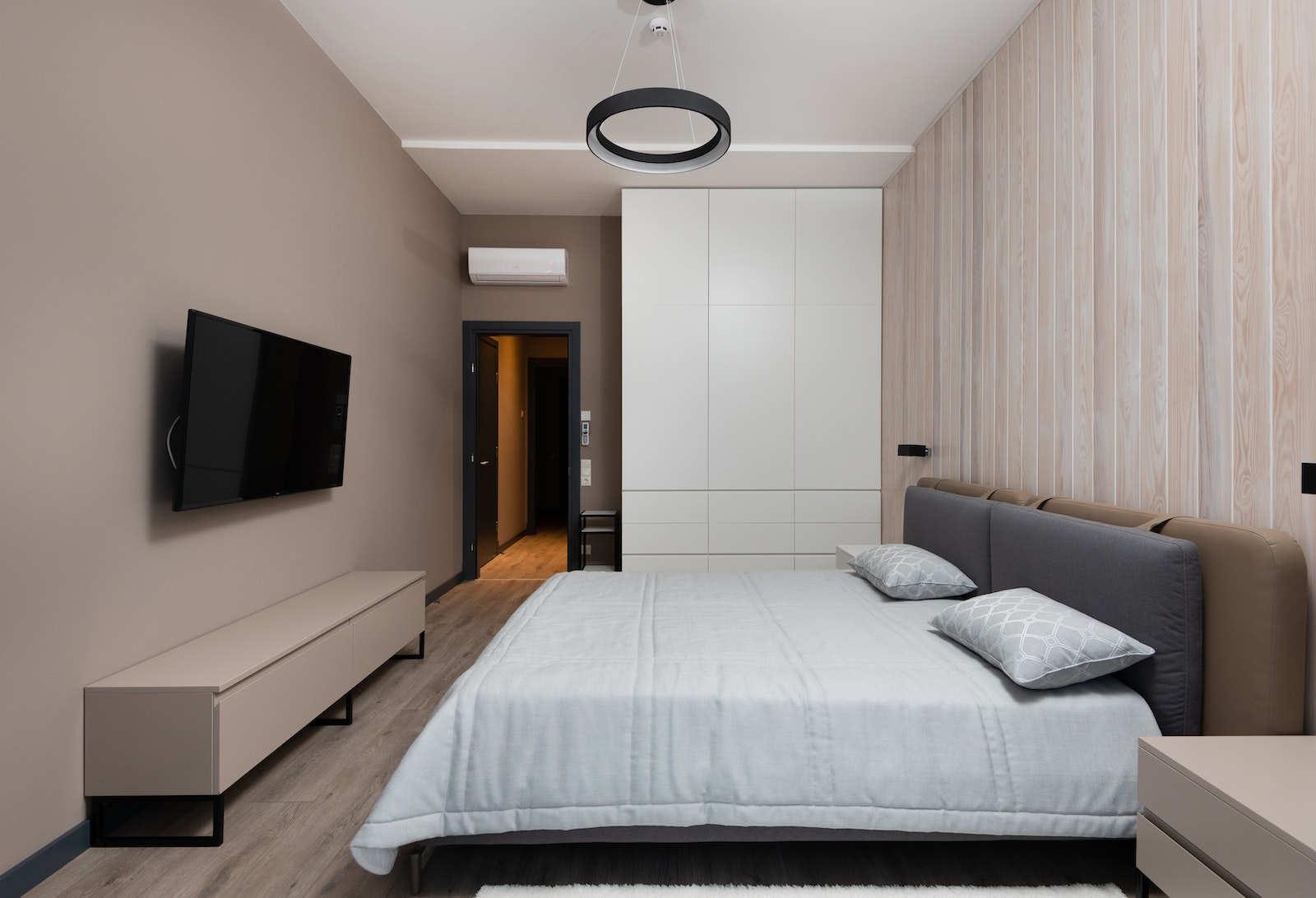 Modern bedroom interior with minimalist furniture and wooden parquet