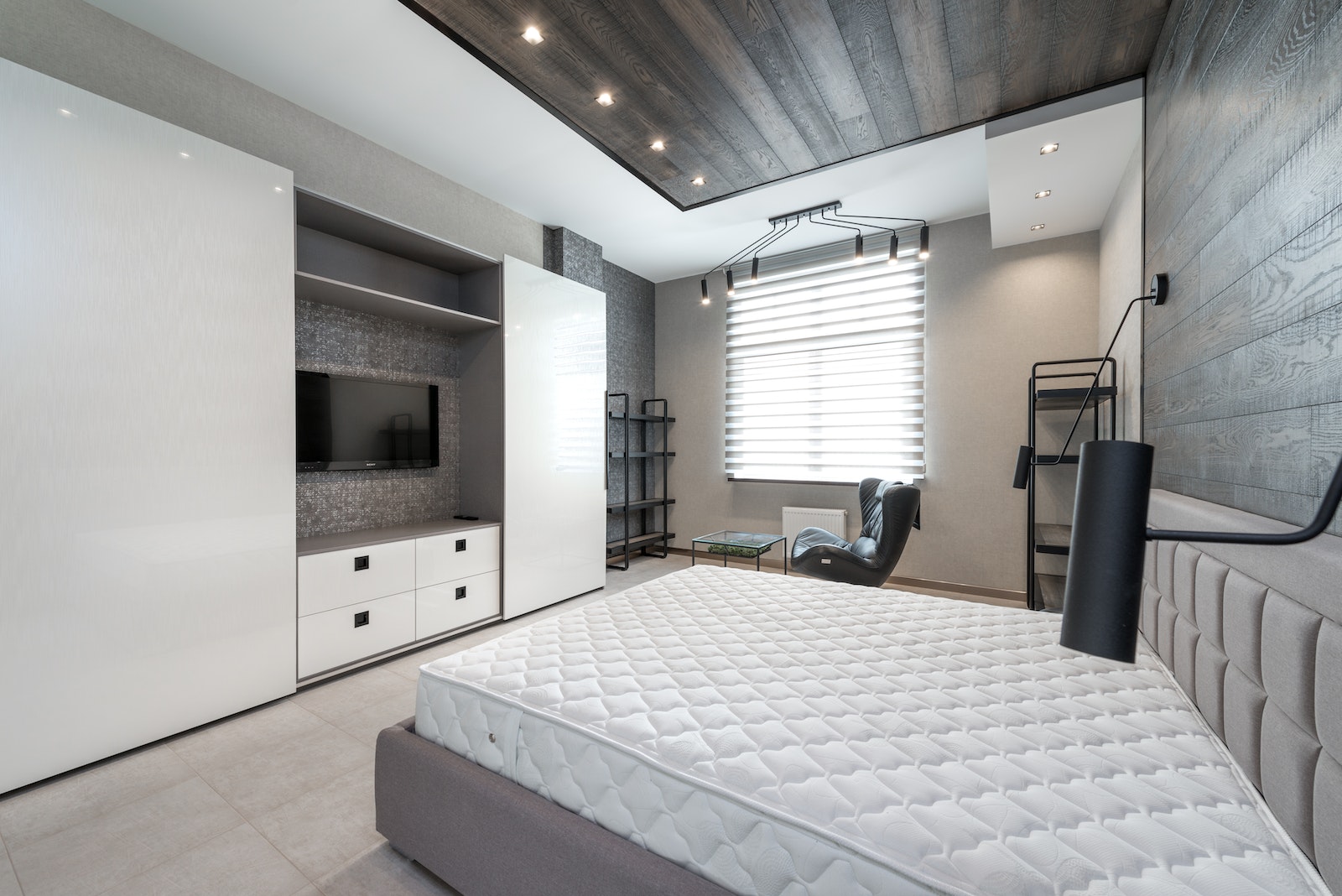 Stylish bedroom with TV and bed