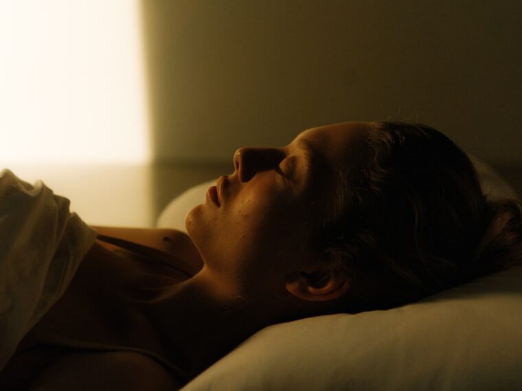 Photo of a Woman Sleeping on the Bed